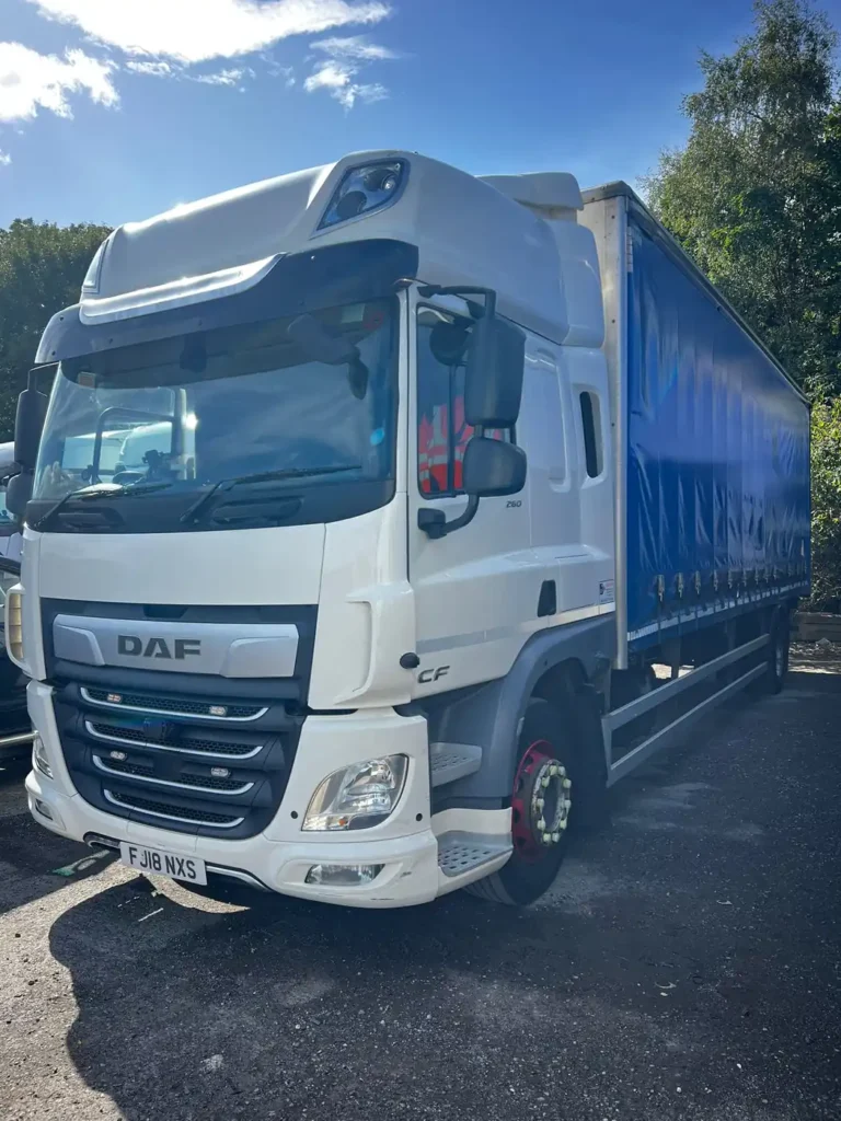 DAF CF curtainsider truck parked in a yard, front three-quarter view