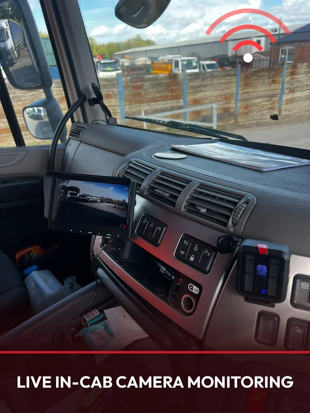 In-cab monitor displaying a live rear-view camera feed inside an HGV cab
