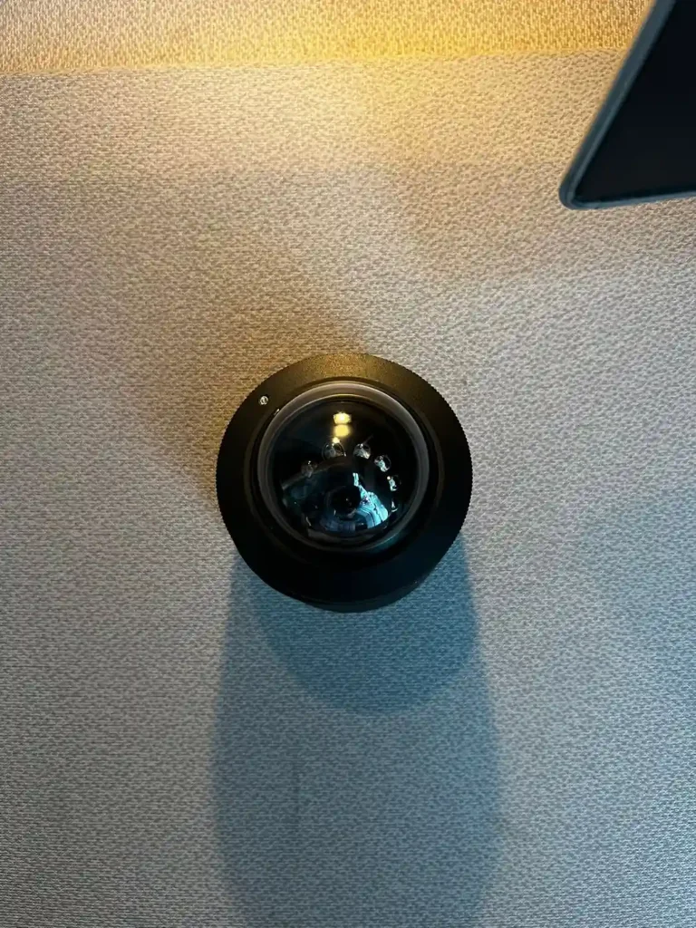 Close-up of a vehicle safety camera lens mounted on an interior cab panel